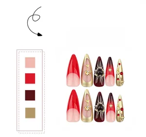 Macro detail of red stiletto press-on nails with silver cross and heart gemstones