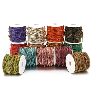 Vibrant rhinestone claw chains on spools in various colors for DIY clothing projects