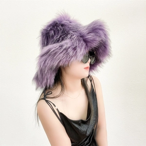 Detail of purple faux fur winter hat styled with a black dress and sunglasses