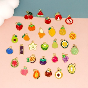 Macro shot of colorful enamel fruit charms with gold plating for DIY jewelry making