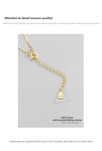 Detailed macro view of S925 sterling silver hallmark on the teardrop-shaped necklace tag