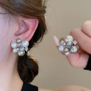 Detailed view of handmade flower pearl earrings with elegant silver cluster design