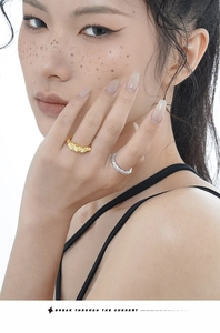 Close-up of gold and silver rings featuring unique tinfoil texture and crinkled design