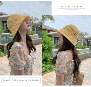 Vue en extérieur d'un chapeau cloche en maille jaune pour femme en vacances d'été
