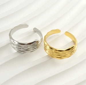 Detailed macro view of 18k gold and silver adjustable rings with lava rock texture