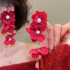 Elegant red fabric flower earrings with long gold tassels and crystal charms