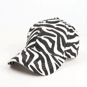 Detail of baseball cap showing black and white zebra print and curved brim texture