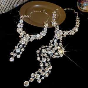 Detail of sparkling rhinestone tassel necklace with silver finish for elegant evening wear