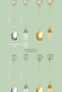 Detail view of gold and silver moon pendant stainless steel dessert spoon and fork set