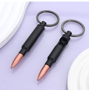 Macro view of matte black bullet bottle opener keychain with bronze tip detail