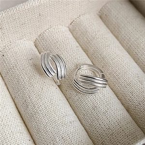 Minimalist S925 sterling silver multi-layer hoop earrings on a beige jewelry display tray