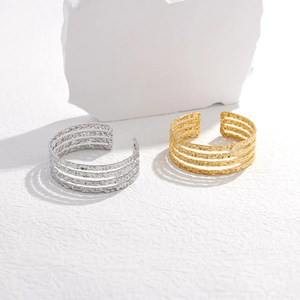 Detail of gold and silver open rings featuring a multi-layer hollow hammered metal texture