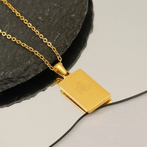Golden stainless steel rectangle dragon pendant necklace on natural stone and mirror surface