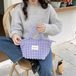 Detail of purple popcorn texture tote bag with Love Sozakka label on casual model