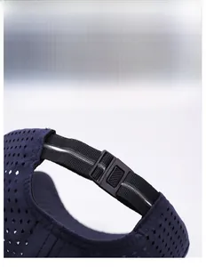 Detail of adjustable snapback buckle and breathable diamond perforated mesh on navy sun hat