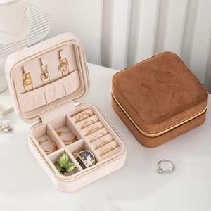Elegant velvet jewelry travel case with necklace hooks and ring slots in cream and caramel