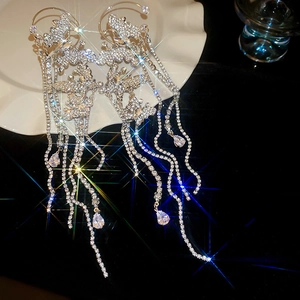 Macro shot of silver tassel butterfly ear cuff with sparkling rhinestones and crystal pendants