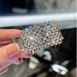 Macro shot of sparkling rhinestones on the silver alloy high ponytail shark clip