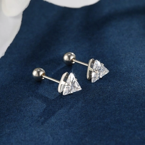 Macro detail of triangle zircon stud earrings with secure screw-back ball closures