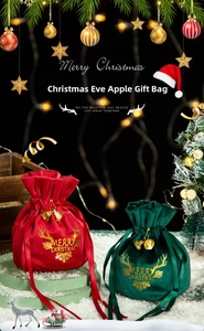 Velvet Christmas drawstring gift bags with gold reindeer motifs and bells in red and green