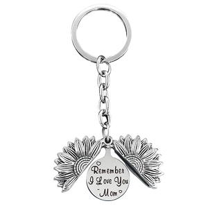 Close-up of engraved sun flower locket keychain with Remember I Love You Mom message