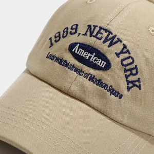 Khaki cotton baseball cap with detailed 1989 New York embroidery and American text