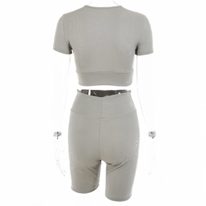 Rear view of women's grey ribbed two-piece set with short sleeve crop top and high waist shorts