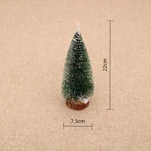 Detailed view of 22cm mini Christmas tree with snow-tipped needles on wood base