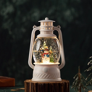 White vintage Christmas snow globe lantern with snowman and warm light on wood base