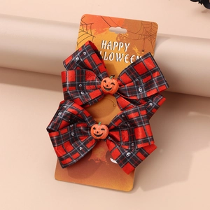 Detail of red and black checkered Halloween hair clips with orange pumpkin decor