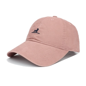 Detail of pink cotton baseball cap with blue dog embroidery and curved wide brim