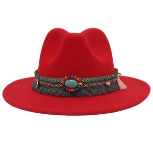 Detail of red wool felt cowboy hat featuring bohemian turquoise beads and tassel band