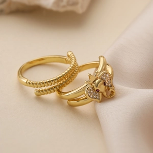 Gold-plated elephant ring set with sparkling zircons on a beige silk background