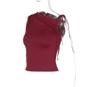Detail of burgundy sleeveless top with asymmetrical shoulder and side drawstring ruching