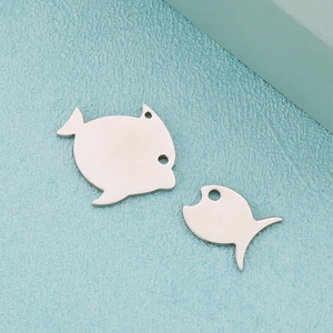 Minimalist silver tropical fish pendant in stainless steel shown from a close-up angle