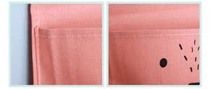 Detail of pink canvas wall hanging bag showing neat stitching and fabric texture