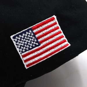 Close-up of premium USA flag embroidery on high-quality black cotton baseball cap
