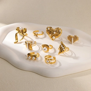 Set of 9 gold stainless steel rings with white pearls, bow and heart designs