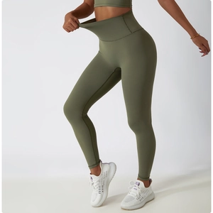 Close-up of olive green high-waisted yoga pants showing high elasticity and shaping effect