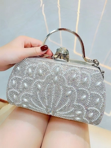 Detail of silver evening clutch bag with sparkling rhinestones and marquise pearl patterns