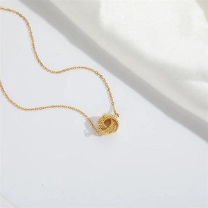 Elegant gold choker necklace featuring a woven twisted rope round pendant on a thin chain