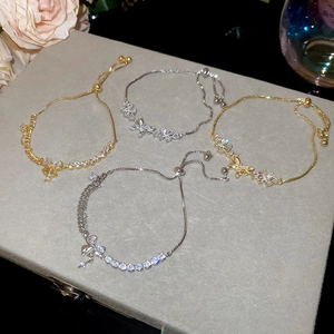 Macro detail of 18k gold plated butterfly bracelets with sparkling zircon stones