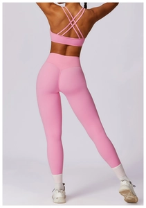 Rear view of pink yoga set showing criss-cross back sports bra and high-waisted leggings
