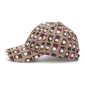 Side view of a khaki baseball cap with cartoon character print and curved brim