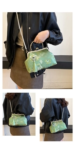 Detail of green floral shell bag with pearl chain, tassel, and vintage metal clasp