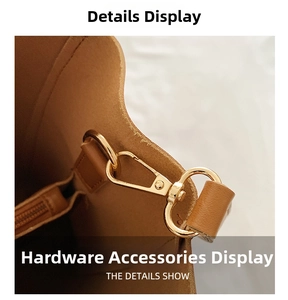Detail of light gold hardware hook on brown leather bucket bag with fine edge finishing