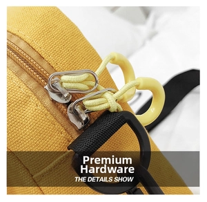 Close-up of durable yellow canvas bag featuring a smooth metal zipper and nylon puller