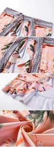 Detail view of tropical palm tree print wrap skirt with layered ruffles and geometric borders