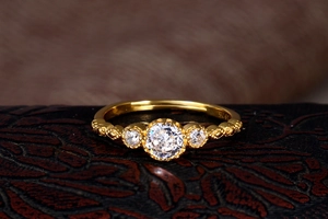 Macro shot of S925 engraved stamp and vintage lace texture on the gold ring band