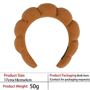 Detailed macro view of the caramel knitted headband with unique scalloped wave edges